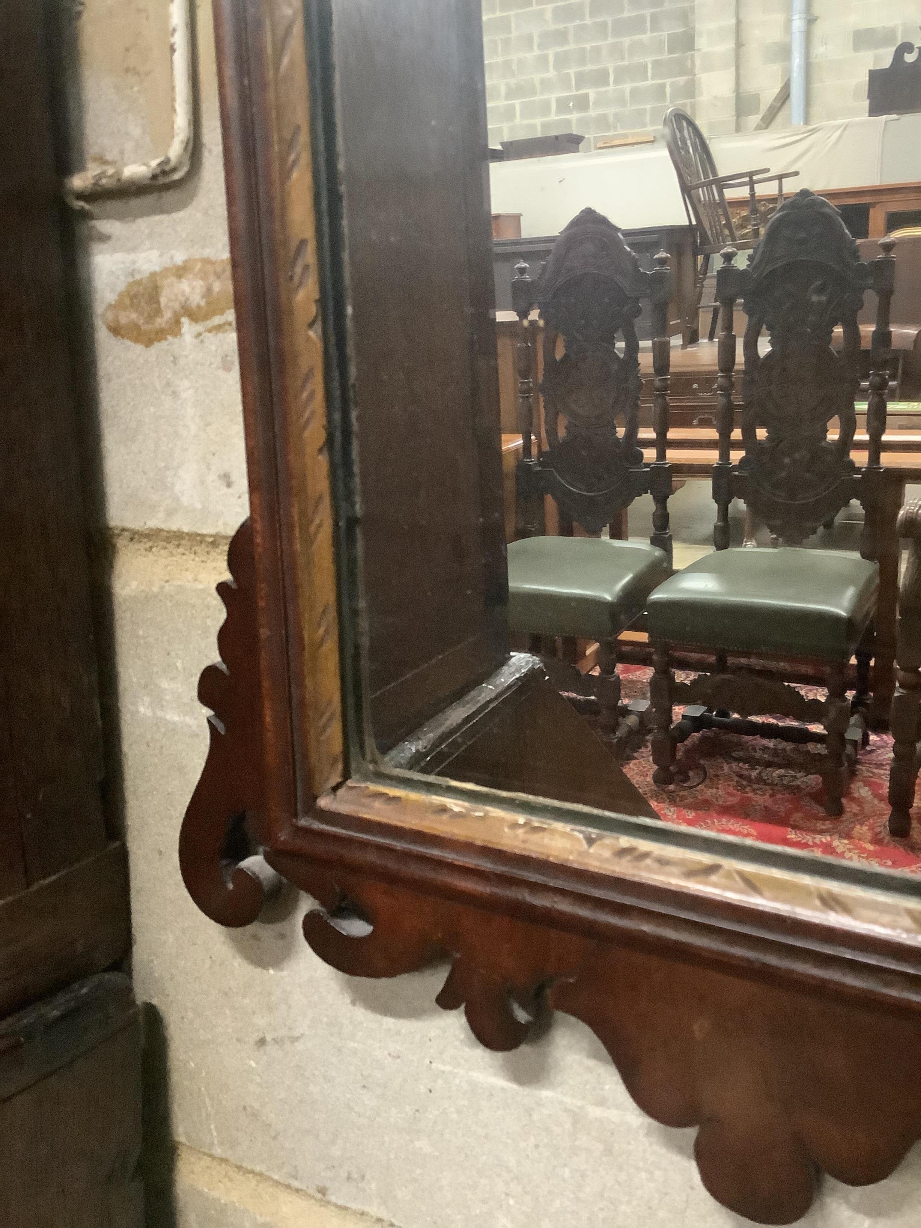 An early 19th century mahogany fret cut wall mirror, width 38cm, height 64cm. Condition - fair